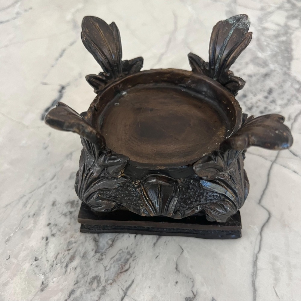 Ornate bronze or metal candle stand